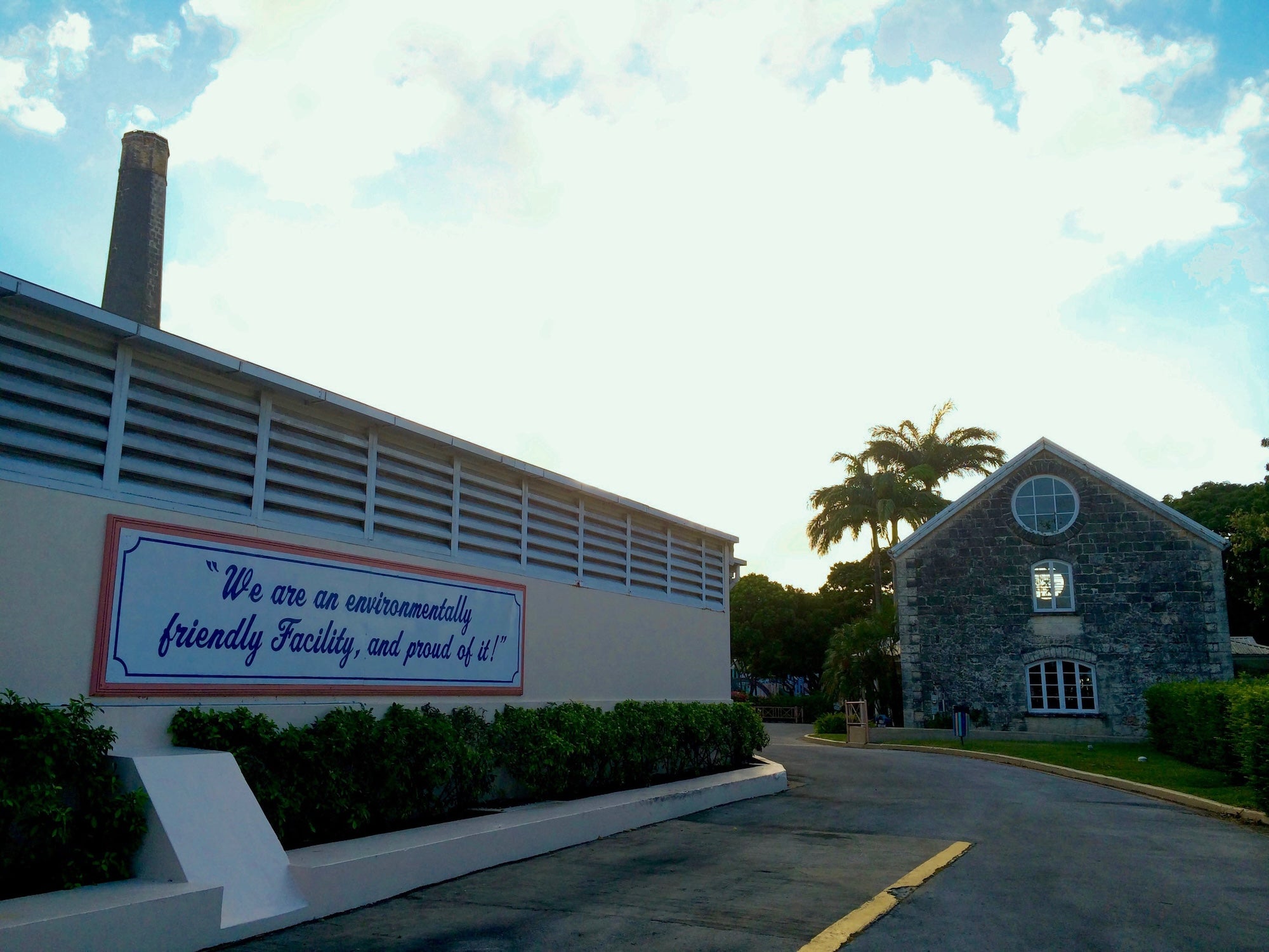 image of exterior of Foursquare Distillery in Barbados with sign that states "We are an environmentally friendly facility, and proud of it!"