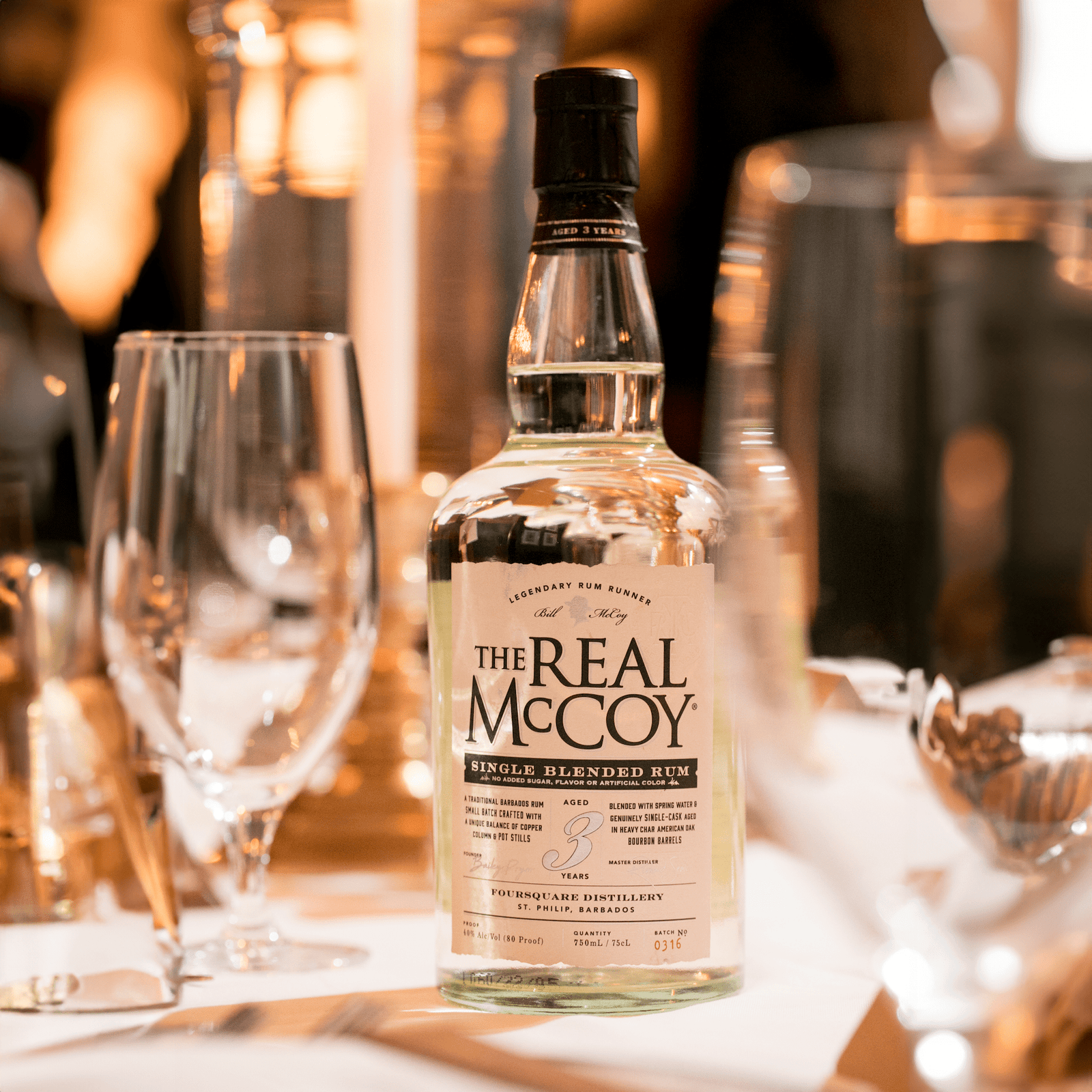 Real McCoy 3 Year Premium Aged Rum on a table with candles and fancy glassware at the Polo Bar. The best rum for a mojito.